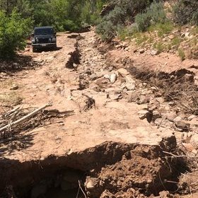 Photo of a road washed out on the Rimrocker Trail
